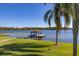 Serene lakeside gazebo with dock, perfect for enjoying water views at 2115 Lake Crescent Ct, Windermere, FL 34786