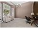 Home office with built-in shelving, plush seating and natural light at 2115 Lake Crescent Ct, Windermere, FL 34786
