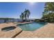 Inviting pool area with spa and lake view; perfect for relaxation and entertaining at 2115 Lake Crescent Ct, Windermere, FL 34786