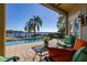 Stunning pool and lake view from covered patio at 2115 Lake Crescent Ct, Windermere, FL 34786