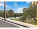 Balcony view with mature trees, lush landscaping, and a tranquil river at 510 Cranes Way # 306, Altamonte Springs, FL 32701