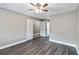 Bright bedroom features stylish gray walls, wood-look floors and ceiling fan at 510 Cranes Way # 306, Altamonte Springs, FL 32701