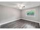 Bright bedroom features stylish gray walls, wood-look floors and ceiling fan at 510 Cranes Way # 306, Altamonte Springs, FL 32701