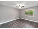Bright bedroom features stylish gray walls, wood-look floors and ceiling fan at 510 Cranes Way # 306, Altamonte Springs, FL 32701