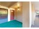 Building entrance showing unit 306 with a red door, carpeted floor, and beige exterior at 510 Cranes Way # 306, Altamonte Springs, FL 32701