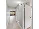 Long hallway with tile flooring, neutral paint, and access to multiple rooms at 510 Cranes Way # 306, Altamonte Springs, FL 32701