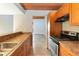 Kitchen area featuring wood cabinets, tile floors, and stainless steel appliances at 510 Cranes Way # 306, Altamonte Springs, FL 32701