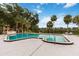 Community pool with lush landscaping and views of the adjacent lake at 510 Cranes Way # 306, Altamonte Springs, FL 32701