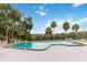 Community pool surrounded by lush landscaping and with views of the adjacent lake at 510 Cranes Way # 306, Altamonte Springs, FL 32701