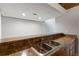 Interior wet bar area with stainless steel sink and brown laminate countertop space, ready for entertaining and easy cleanups at 510 Cranes Way # 306, Altamonte Springs, FL 32701