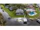 Aerial view of a waterfront home, featuring lush landscaping and a private dock at 6009 Lady Bet Dr, Orlando, FL 32819