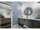 Stylish bathroom with modern vanity, decorative mirror, and adjacent bedroom view at 6009 Lady Bet Dr, Orlando, FL 32819