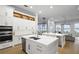 Spacious white kitchen featuring double islands, stainless steel appliances, and views of the lake at 6009 Lady Bet Dr, Orlando, FL 32819