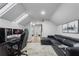 Upstairs living area with gaming setup, skylight, and black leather sofa at 6009 Lady Bet Dr, Orlando, FL 32819