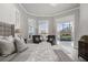 Bright main bedroom with French doors leading to outdoor pool and an elegant seating area at 6009 Lady Bet Dr, Orlando, FL 32819