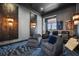 Luxurious media room featuring comfortable seating, custom wall art, and dimmable sconce lighting at 6009 Lady Bet Dr, Orlando, FL 32819