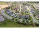 Aerial view of a residential neighborhood featuring a blue house among other well-maintained homes at 15542 Sunquat Dr, Winter Garden, FL 34787