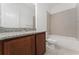 A clean, well lit bathroom with a tub and shower combination and granite vanity at 15542 Sunquat Dr, Winter Garden, FL 34787