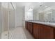 A Primary bathroom features a walk-in shower, double vanity, and ample storage at 15542 Sunquat Dr, Winter Garden, FL 34787