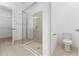 The bright bathroom features a glass enclosed shower with neutral tile at 15542 Sunquat Dr, Winter Garden, FL 34787