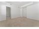 A bright, open bedroom with neutral walls, carpet, and access to the bathroom at 15542 Sunquat Dr, Winter Garden, FL 34787