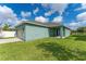 Inviting home exterior with well-maintained lawn, covered patio, and attached two-car garage at 15542 Sunquat Dr, Winter Garden, FL 34787