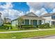 Charming one-story home with blue siding, a well-kept lawn, and neatly trimmed hedges at 15542 Sunquat Dr, Winter Garden, FL 34787