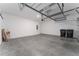 Two-car garage with overhead storage racks and ample space for vehicles and storage at 15542 Sunquat Dr, Winter Garden, FL 34787