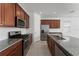 An open kitchen features stainless steel appliances, granite countertops and ample cabinet space at 15542 Sunquat Dr, Winter Garden, FL 34787