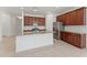 The kitchen features a large center island, tile floors, and rich wooden cabinets at 15542 Sunquat Dr, Winter Garden, FL 34787