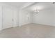 Bright living room with neutral tile floors, a modern chandelier, and a view to the entry at 15542 Sunquat Dr, Winter Garden, FL 34787
