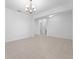 Spacious, bright living room with neutral tiled floors and modern lighting fixture at 15542 Sunquat Dr, Winter Garden, FL 34787