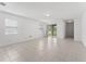 An open living room featuring tile floors, ample natural light, and a sliding glass door at 15542 Sunquat Dr, Winter Garden, FL 34787