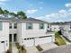 Two-story home with white exterior, two-car garage, and landscaping at 2920 Oak Park Way # Apt A, Orlando, FL 32822