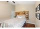 This cozy bedroom features a wood accent wall and dark hardwood floors at 807 Grovesmere Loop, Ocoee, FL 34761