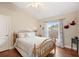 Comfortable bedroom with hardwood floors, ceiling fan, closet, and window with curtains at 807 Grovesmere Loop, Ocoee, FL 34761