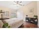 Bright bedroom featuring a ceiling fan, closet, window view, and decor for comfortable living at 807 Grovesmere Loop, Ocoee, FL 34761