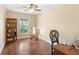 Charming bedroom with hardwood floors, natural light, a rocking chair, and a built-in bookshelf at 807 Grovesmere Loop, Ocoee, FL 34761
