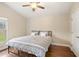 Bright bedroom featuring hardwood floors, a modern bed frame, and natural light from a window at 807 Grovesmere Loop, Ocoee, FL 34761