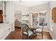 Charming dining nook boasts hardwood floors, a pendant light, and a view of the screened-in outdoor pool area at 807 Grovesmere Loop, Ocoee, FL 34761