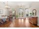 Formal dining room with hardwood floors, elegant chandelier, and a view into the foyer at 807 Grovesmere Loop, Ocoee, FL 34761