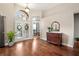 Elegant foyer featuring hardwood floors, a stylish mirror, and a view into the office at 807 Grovesmere Loop, Ocoee, FL 34761