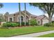 Charming single-story home featuring a manicured lawn, mature trees, and a two-car garage at 807 Grovesmere Loop, Ocoee, FL 34761
