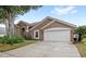 A spacious garage, complemented by a well-maintained lawn and beautiful landscaping at 807 Grovesmere Loop, Ocoee, FL 34761
