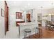 Spacious open kitchen with stainless appliances, island, tile floors, and dining area at 807 Grovesmere Loop, Ocoee, FL 34761