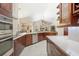 Bright kitchen features stainless appliances, granite countertops, tile floors, and dark wood cabinets at 807 Grovesmere Loop, Ocoee, FL 34761