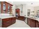 Open kitchen with stainless appliances, granite counters, and modern range hood at 807 Grovesmere Loop, Ocoee, FL 34761