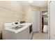 Efficient laundry room with modern washer and dryer units and convenient shelving for storage at 807 Grovesmere Loop, Ocoee, FL 34761