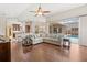 Spacious living room boasts hardwood floors, modern furnishings, and seamless access to a screened pool area at 807 Grovesmere Loop, Ocoee, FL 34761