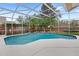 Beautiful pool featuring tropical landscaping and a screened enclosure at 807 Grovesmere Loop, Ocoee, FL 34761